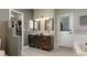 Stylish bathroom featuring double sinks, modern fixtures, and ample counter space with easy access to the closet at 2539 Lake Meadow Dr, Lafayette, CO 80026