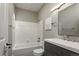 Bright bathroom featuring white tiled shower, a modern vanity, and neutral walls, creating a clean and stylish space at 2539 Lake Meadow Dr, Lafayette, CO 80026