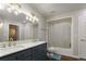 Modern bathroom with stylish vanity, double sinks, elegant lighting, and a shower-tub with modern fixtures at 2539 Lake Meadow Dr, Lafayette, CO 80026