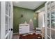 Adorable Bedroom displaying green accent wall, wooden mountain art, a deer bust, and white decor at 2539 Lake Meadow Dr, Lafayette, CO 80026