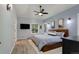 Serene bedroom with light blue walls, wood flooring, and large windows offering plenty of natural light at 2539 Lake Meadow Dr, Lafayette, CO 80026