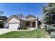 Charming single-story home featuring well-manicured lawn and mature landscaping at 2539 Lake Meadow Dr, Lafayette, CO 80026