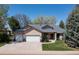 Charming single-Gathering home featuring a well-manicured lawn, mature trees, and a spacious two-car garage at 2539 Lake Meadow Dr, Lafayette, CO 80026
