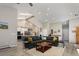 Bright living room with a soaring ceiling, skylights, and an open floor plan that seamlessly connects to the kitchen at 2539 Lake Meadow Dr, Lafayette, CO 80026