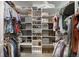 Spacious walk-in closet offering ample storage with built-in shelving and hanging rods for organization at 2539 Lake Meadow Dr, Lafayette, CO 80026