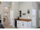 Chic wet bar featuring white cabinets, a wooden countertop, and a built-in wine fridge at 2539 Lake Meadow Dr, Lafayette, CO 80026