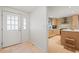 Inviting entryway with a view into a kitchen featuring modern appliances and stylish finishes at 7359 S Monaco St, Centennial, CO 80112