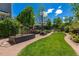 Large landscaped backyard with garden, patio area and lush green lawn at 902 Jarvis Dr, Erie, CO 80516