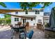 Grey two-story home's backyard featuring an outdoor kitchen and patio at 902 Jarvis Dr, Erie, CO 80516
