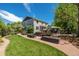 A spacious backyard boasts a lush lawn, patio with sunshade, and raised garden beds at 902 Jarvis Dr, Erie, CO 80516