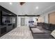 Spacious basement features a flat screen TV and comfortable gray sectional sofa at 902 Jarvis Dr, Erie, CO 80516
