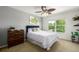 This bedroom features light gray walls, a ceiling fan, and a large window at 902 Jarvis Dr, Erie, CO 80516