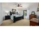 This primary bedroom features a ceiling fan and coordinating furniture sets at 902 Jarvis Dr, Erie, CO 80516
