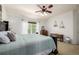 This bedroom features light carpet and a ceiling fan at 902 Jarvis Dr, Erie, CO 80516