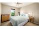 This bedroom features a light color scheme, a ceiling fan, and a dresser at 902 Jarvis Dr, Erie, CO 80516