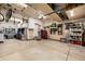Spacious garage featuring ample storage cabinets, work area, and overhead storage racks at 902 Jarvis Dr, Erie, CO 80516