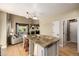 Spacious kitchen with island, stainless appliances, hardwood flooring, and natural light at 902 Jarvis Dr, Erie, CO 80516