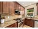Well-appointed kitchen with stainless steel appliances, granite countertops, and custom cabinets at 902 Jarvis Dr, Erie, CO 80516
