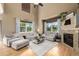 Bright living room featuring vaulted ceilings, hardwood floors, fireplace and ample seating at 902 Jarvis Dr, Erie, CO 80516