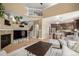 Spacious living room open to kitchen, with hardwood floors and fireplace at 902 Jarvis Dr, Erie, CO 80516