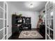 A home office with a large desk area, hardwood floors, and natural light at 902 Jarvis Dr, Erie, CO 80516