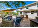 Back patio with outdoor dining, lounge area, fire pit, and a protective sunshade at 902 Jarvis Dr, Erie, CO 80516