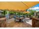 Spacious outdoor dining area featuring sun shade, BBQ, and stylish seating surrounded by nature at 902 Jarvis Dr, Erie, CO 80516