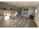 Sunlit bonus room featuring built-in shelving, wood flooring, and space for activities at 3766 S Nelson Way, Denver, CO 80235