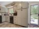 Well-lit kitchen features gray cabinets, black hardware, and a garden view through the glass door at 3766 S Nelson Way, Denver, CO 80235