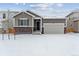 Two-story house with snow-covered lawn and attached garage at 4519 Boone Cir, Brighton, CO 80601