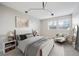 Bright bedroom boasts natural light from two windows and is furnished with a cozy armchair and a modern bed at 6490 S Dayton St # L02, Englewood, CO 80111
