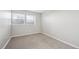Bright bedroom with two windows that provide natural light and neutral walls at 6490 S Dayton St # L02, Englewood, CO 80111