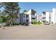 Modern apartment complex with a well-maintained parking area, appealing architectural design, and ample landscaping at 6490 S Dayton St # L02, Englewood, CO 80111