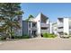 Exterior view of the condominium with well-maintained landscaping, parking, and gray and white facade at 6490 S Dayton St # L02, Englewood, CO 80111