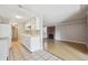 Open layout kitchen with tile floors, white cabinets, and view to the living room with fireplace at 6490 S Dayton St # L02, Englewood, CO 80111