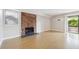 Bright living room with hardwood floors, fireplace, sliding doors to patio and neutral walls at 6490 S Dayton St # L02, Englewood, CO 80111