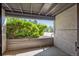 Outdoor patio area with beautiful green shrubbery, natural light and hardscaped wall at 6490 S Dayton St # L02, Englewood, CO 80111