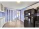 Bright kitchen with white cabinets and black appliances at 8610 Jolene Dr, Denver, CO 80229