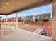 Back patio with a view of the backyard, fenced-in yard, and neighboring houses at 857 Gold Hill Dr, Erie, CO 80516