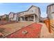 Backyard showcasing a patio, wooden fence, manicured landscape with mulch, and nearby homes at 857 Gold Hill Dr, Erie, CO 80516