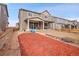 Backyard with a patio, fire pit, wooden fence, and red mulch landscaping at 857 Gold Hill Dr, Erie, CO 80516
