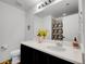 Bright bathroom featuring a single sink with a quartz countertop and a shower at 857 Gold Hill Dr, Erie, CO 80516