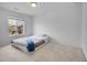 Clean bedroom featuring soft carpeting, natural light from a window and a bed on the floor at 857 Gold Hill Dr, Erie, CO 80516