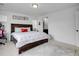 Bedroom with dark wooden bed frame, bright lighting, soft carpeting, and a view to a bathroom at 857 Gold Hill Dr, Erie, CO 80516