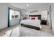 Sunlit bedroom with large window, a queen bed with dark wooden frame and soft, light colored carpet at 857 Gold Hill Dr, Erie, CO 80516