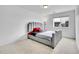 Bright and spacious bedroom featuring soft carpeting and a modern gray bed frame, next to a window at 857 Gold Hill Dr, Erie, CO 80516