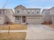 Charming two-story home with a well-maintained front yard and attached two-car garage at 857 Gold Hill Dr, Erie, CO 80516