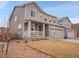 Attractive exterior view of a two-story home featuring a welcoming front porch and low maintenance landscaping at 857 Gold Hill Dr, Erie, CO 80516