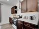 Well-lit kitchen featuring stainless steel appliances, white subway tile backsplash, and dark wood cabinets at 857 Gold Hill Dr, Erie, CO 80516