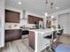 Well-equipped kitchen featuring a spacious island with bar seating, modern appliances, and pendant lighting at 857 Gold Hill Dr, Erie, CO 80516